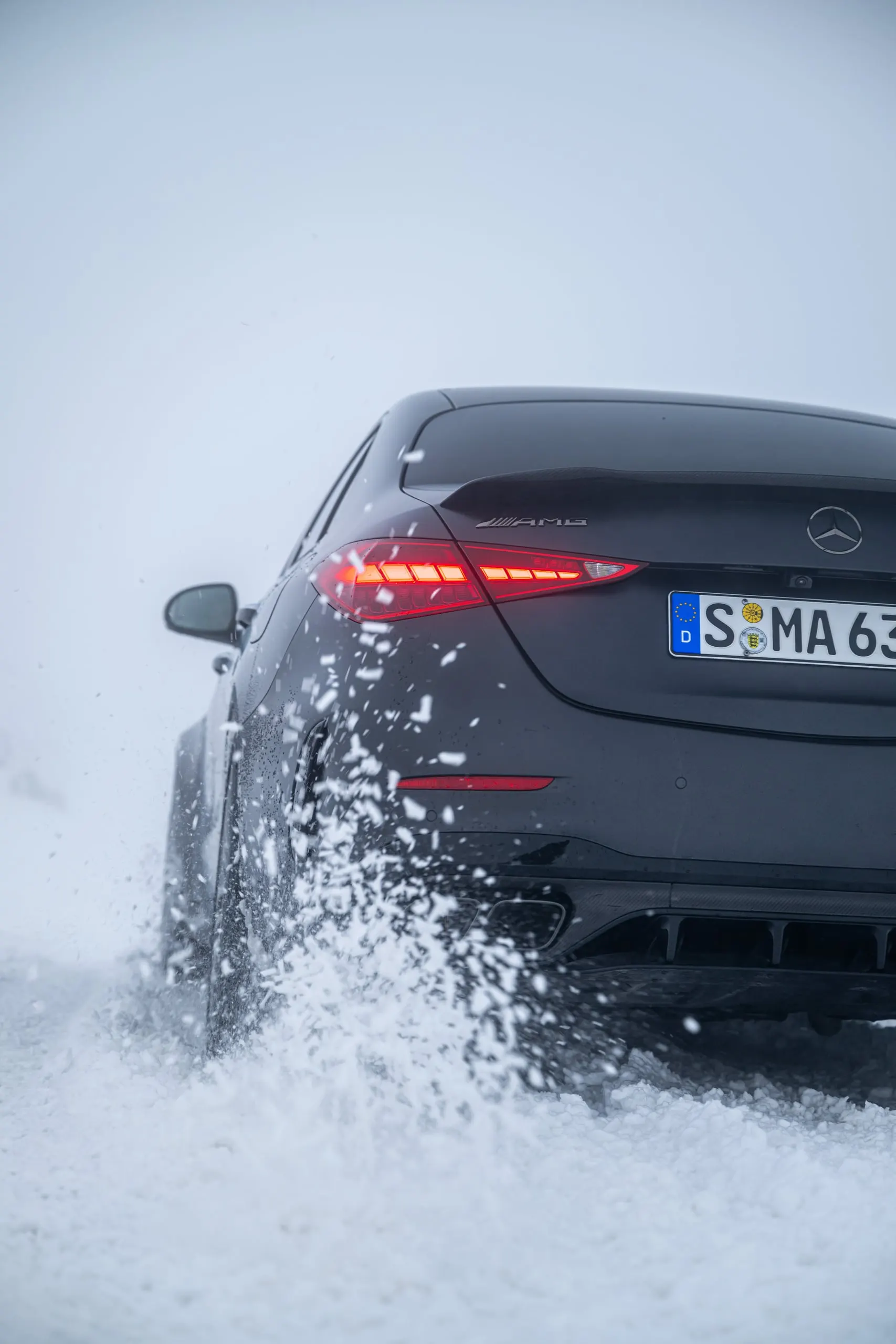 C 63 wirbelt Schnee auf, Heckansicht