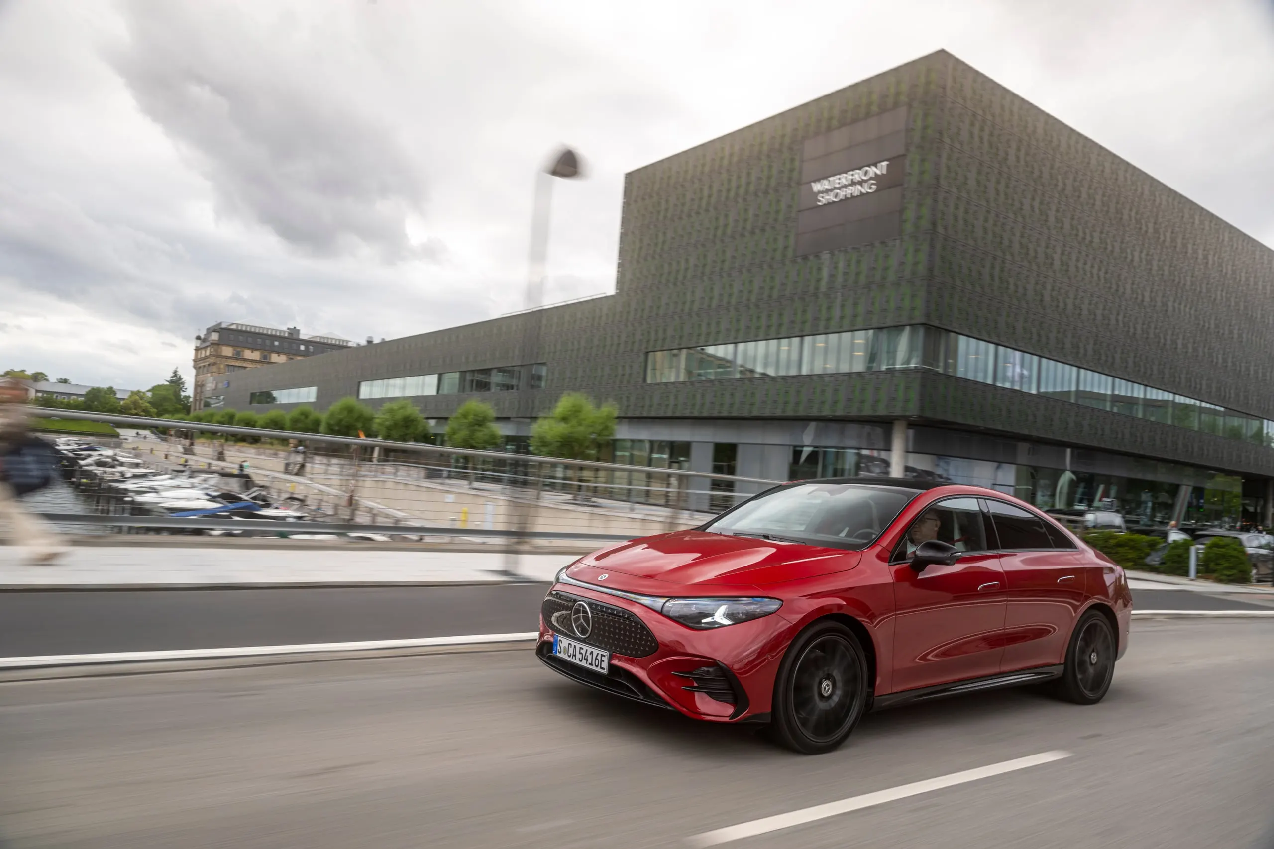 Roter CLA in Fahrt vor moderner Architektur